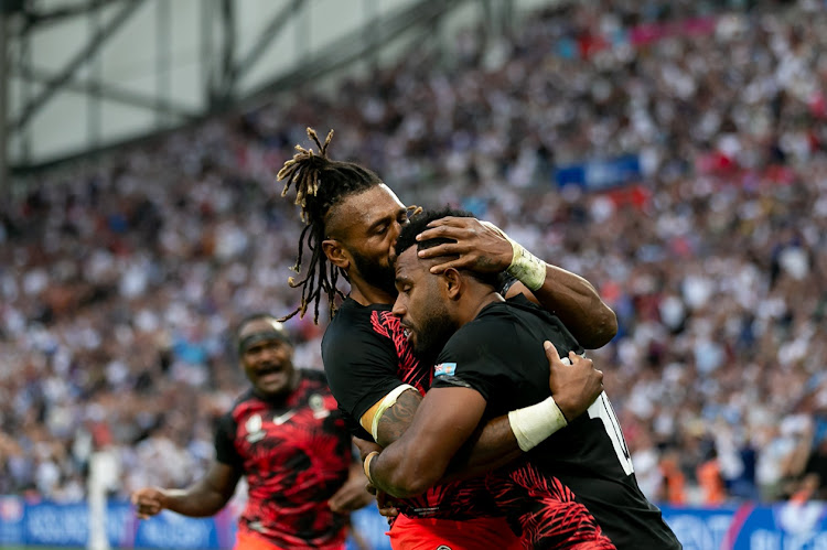 Fiji's Vilimoni Botitu celebrates with his teammate Waisea Nayacalevu after scoring a try in the 2023 Rugby World Cup quarterfinal against England at Stade Velodrome in Marseille on October 15.