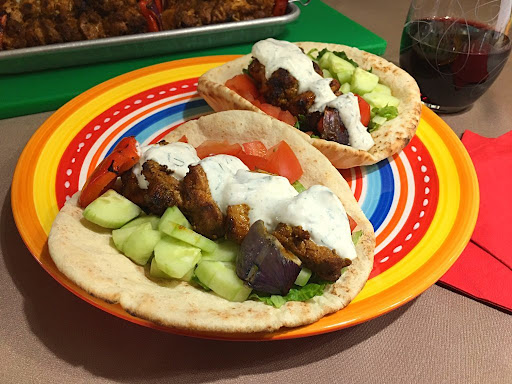 Perfectly grilled chicken pieces served on pita bread with a delicious yogurt sauce.