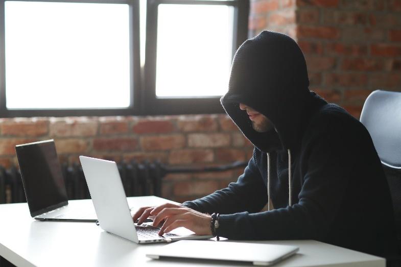 A person sitting at a table using a computer

Description automatically generated with medium confidence