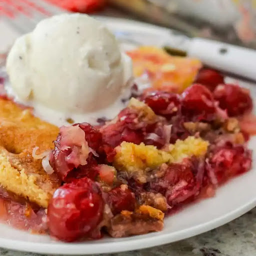 This family-friendly scrumptious dump cake has six easy ingredients comes together in less than ten minutes.  It is perfect for potlucks, neighborhood socials, and family reunions.

