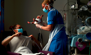 Neonatal Nurse Kirsty Hartley carries newborn Theo Anderson, who was born prematurely, to his mother Kirsty Anderson, in the Neonatal Intensive Care Unit at the Lancashire Women and Newborn Centre at Burnley General Hospital, during the coronavirus outbreak, in Burnley, East Lancashire, Britain, May 15 2020. 