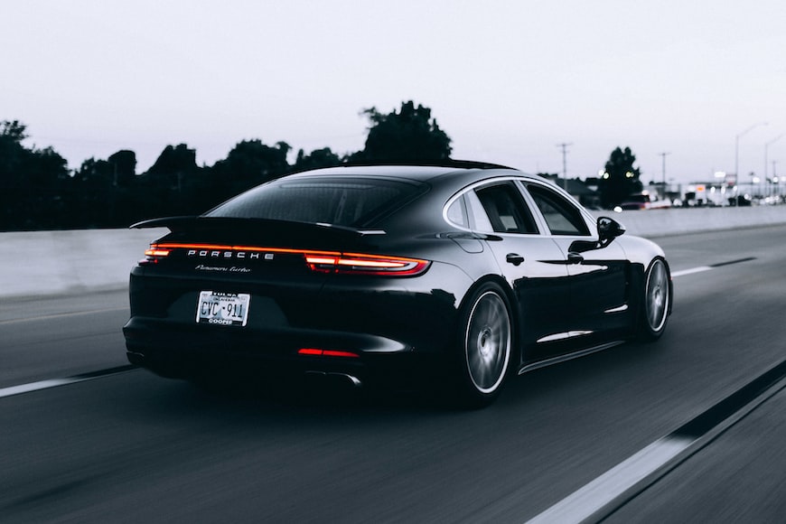 Black Porsche riding down a highway in Illinois.