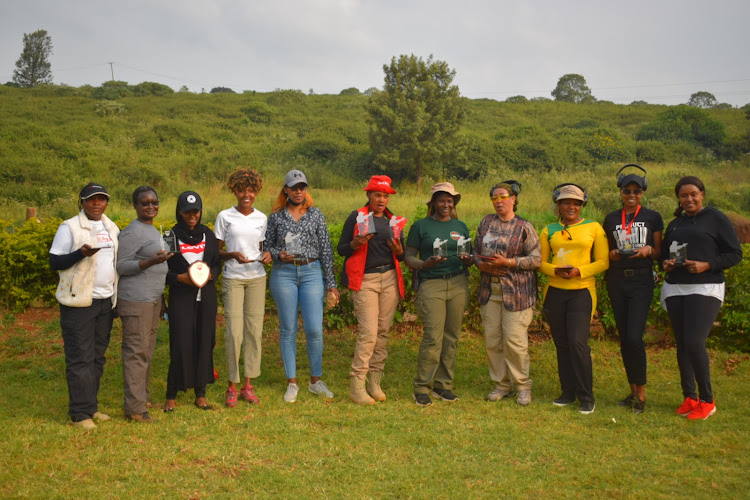 Wachianga (2nd L) with other shooters after an IDPA Tier 1 tournament over the weekend.