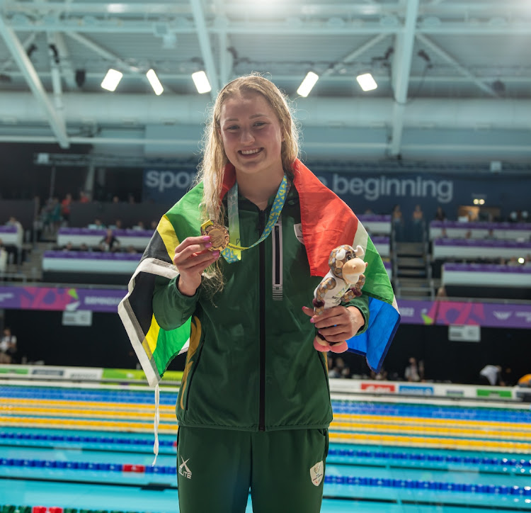 Lara van Niekerk shows off her 50m breaststroke gold at the Commonwealth Games in Birmingham.