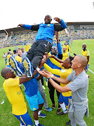 Mamelodi Sundowns coach Pitso Mosimane is hoisted into the air by  his players as they celebrated winning the PSL championship after beating Ajax Cape Town 3-1 in an Absa Premiership match  at the Lucas Moripe Stadium yesterday. /Lefty Shivambu/Gallo Images