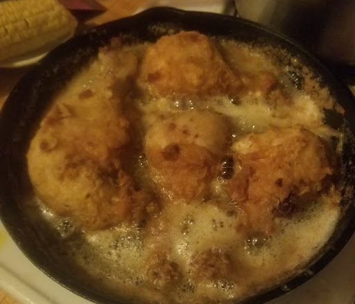 Frying chicken in vegetable oil in cast iron skillet