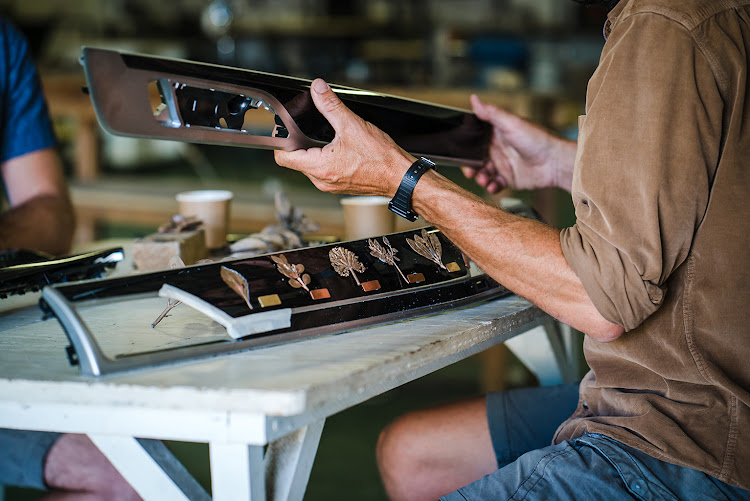 Artist Nic Bladen working on the BMW 745Le xDrive for Ellerman House.