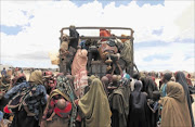 DISPLACED: Families board trucks as they travel back to their home regions from Ala-yasir camp closed by  al Shabab militias near    Somalia's capital Mogadishu.phito: REUTERS