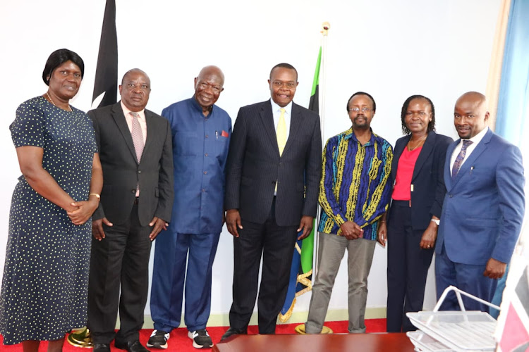 Former Vice President Moody Awori with Busia Governor Paul Otuoma and other officials from the Busia County Assembly in Busia on April 12, 2023.