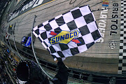 Chris Buescher takes the checkered flag to win the NASCAR Cup Series Bass Pro Shops Night Race at Bristol Motor Speedway on September 17 2022 in Bristol, Tennessee.