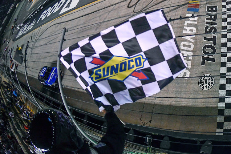 Chris Buescher takes the checkered flag to win the NASCAR Cup Series Bass Pro Shops Night Race at Bristol Motor Speedway on September 17 2022 in Bristol, Tennessee.