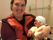 Anthony Croxford in the arms of mother Erica after surgery for juvenile xanthogranuloma.