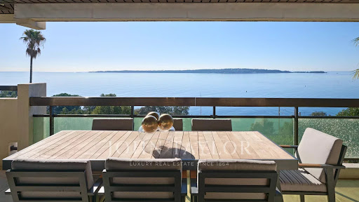 Table and chairs on balcony with sea view in this luxury apartment for sale in Cannes ($2,157,704 - 148 m²)