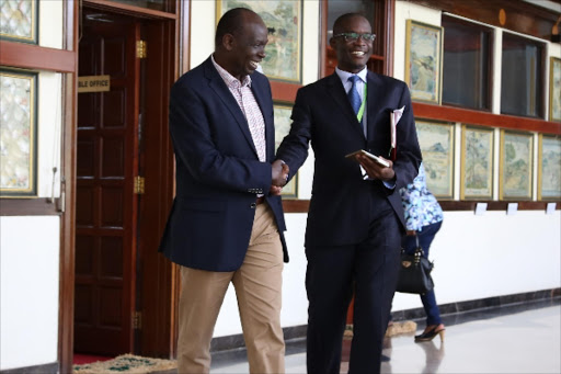 CONTRACT FLAW : Ainabkoi MP Samuel Chepkonga and IEBC chief executive Ezra Chiloba at Parliament Buildings in Nairobi on May 14.