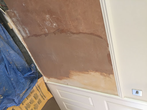 Filled with bonding over hacked off old sand and cement to create a straight line across the skirting board.