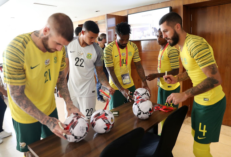 Lars Veldwijk, Ronwen Williams, Thulani Hlatshwayo and Daniel Cardoso of South Africa sign the Afcon tournament official ball at Novotel Hotel in Cairo, Egypt, on June 20 2019.