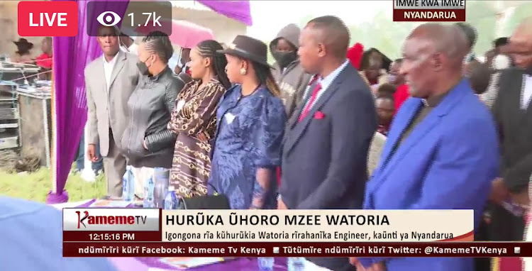 Wambui Kajim in a brown dress, Kiengei's wife Mugure and Kiengei during the burial service in Nyandarua country