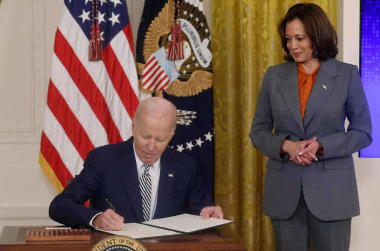 US President Joe Biden signs an executive order about artificial intelligence as vice-president Kamala Harris looks on at the White House in Washington, the US, October 30 2023. Picture: LEAH MILLIS/REUTERS