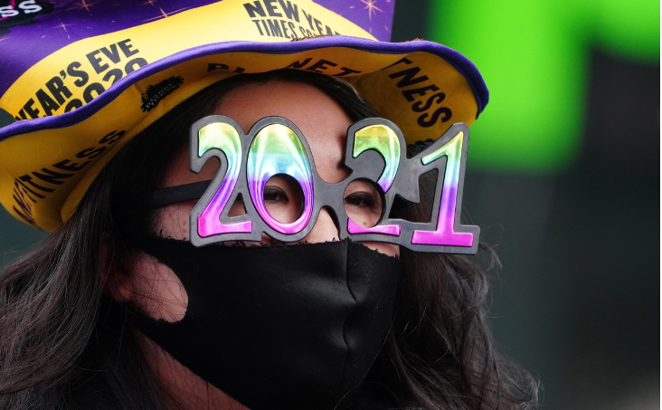 A woman wears '2021' numeral glasses in advance of New Year's eve in Times Square amid the coronavirus disease pandemic in the Manhattan borough of New York City, New York, US on December 21 2020.