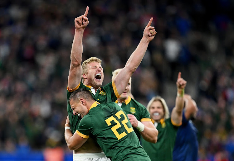 Pieter-Steph du Toit and Handré Pollard celebrate the Springboks' victory at full time after their Rugby World Cup quarterfinal against France at Stade de France on Sunday night.