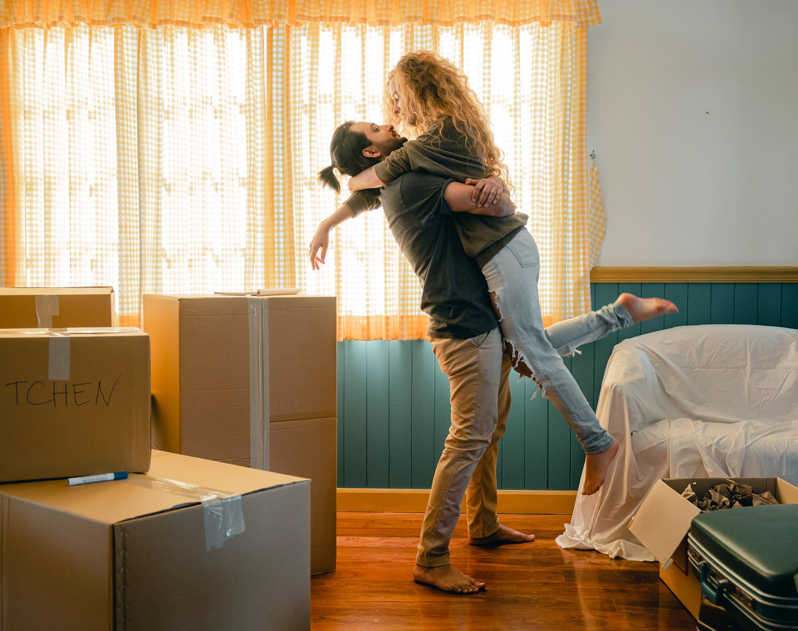 Man and woman couple hugging each other standing at new home