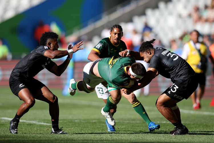 The Blitzboks’ Impi Visser is tackled by Fehi Fineanganofo of New Zealand on day two of the HSBC SVNS Cape Town at Cape Town Stadium on Sunday. Picture: SHAUN ROY/GALLO IMAGES