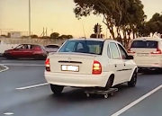 A car using a flatbed trolley as a back wheel was caught on camera driving through traffic in Cape Town this week.