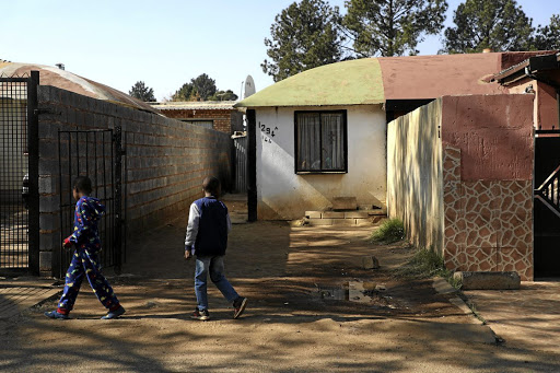 Local children walk past the murder scene where intelligence police officer Ntobeko Nhlanhla Langa was shot dead in White City, Soweto. /Thulani Mbele