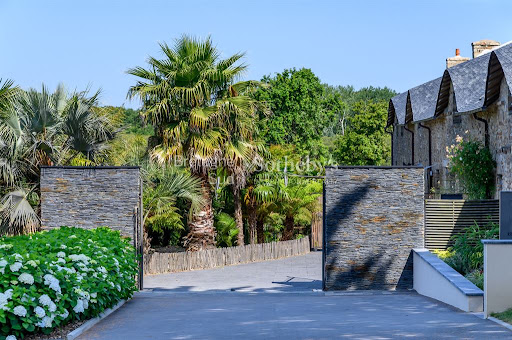 Luxury vacation rental property in Baden (56870) - Entrance with stone gate and lush vegetation