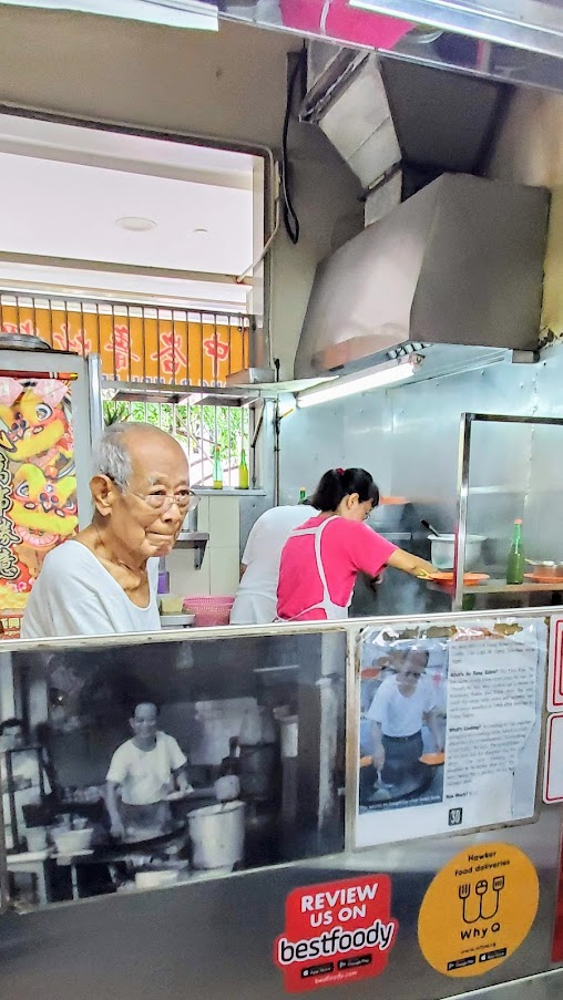 Guide to visiting Hawker Centers in Singapore - Tiong Bahru Char Kway Teow (Stall #02-11) to meet Mr. Tay Soo Nam, who started frying noodles at the age of 24 and although isn't doing the cooking now (he leaves it up to his daughter and husband) is still manning the hawker stall at 90 years old. The only dish to get here is the Char Kway Teow, stir fried rice noodles with chinese sausage, fishcake, cockles and beansprouts.