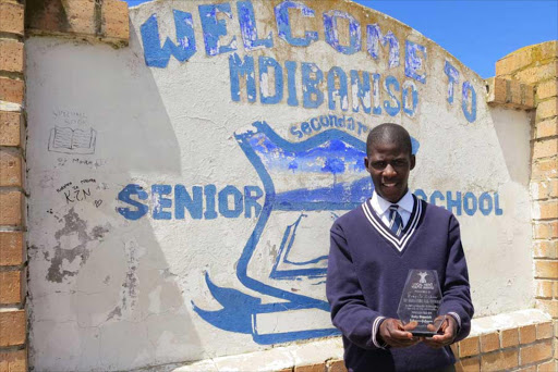 DRIVEN: Local Hero Bongile Sikane from Mdibaniso Secondary School received atrophy from the Daily Dispatch yesterday morning in recognition of the selfless work that he has done in his community Picture: QAQAMBA MAGADLA