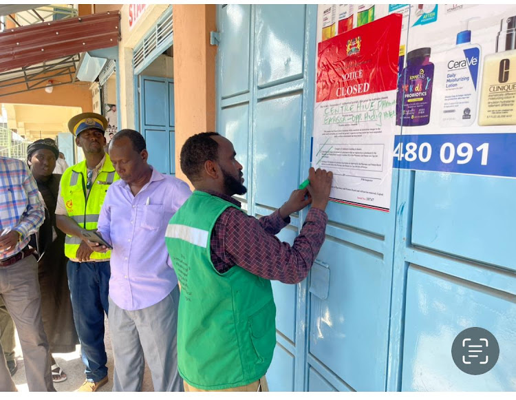 Officials from the pharmacy and poisons board put a sticker to one of the chemists that was closed on Tuesday.