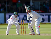 Brendan Taylor of Zimbabwe goes for a shot as former SA wicketkeeper/batsman AB de Villiers watches on from behind the stumps during the Sunfoil Test match at St Georges Park on December 27, 2017 in Port Elizabeth.