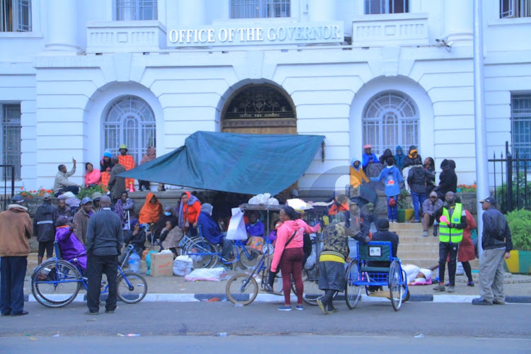 Nairobi business community of persons living with disability outside City Hall where they slept all night on November 15, 2023