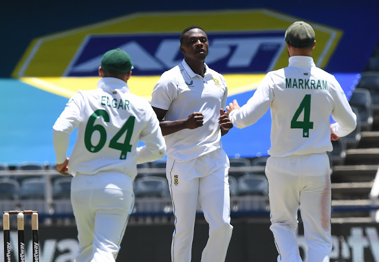 Kagiso Rabada of South Africa celebrates his dismissal of Cheteshwar Pujara with teammates Dean Elgar and Aiden Markram on day 3 of the second Test against India at the Wanderers in Johannesburg on January 5 2022.