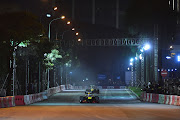 David Coulthard of Scotland and Jake Dennis of England race during the Red Bull Racing show run on April 20 in Hanoi, Vietnam. 