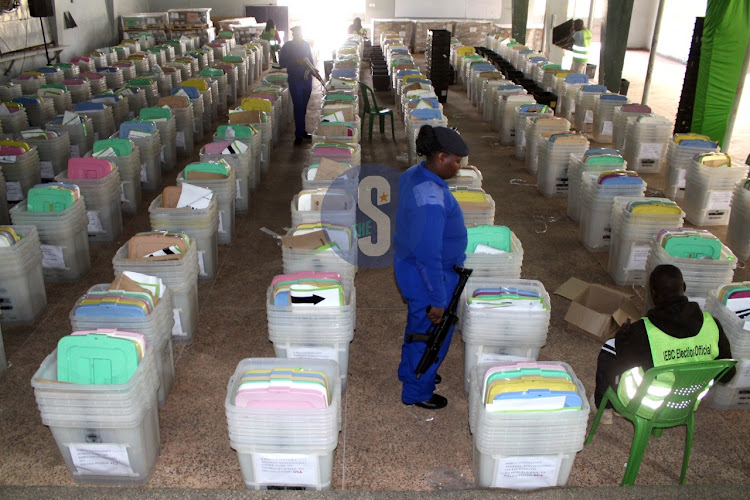 A police officer is seen next to ballot boxes are seen at Upperhill High School, which serves as Kibra constituency tallying centre ahead of Tuesday's general elections on August 7, 2022