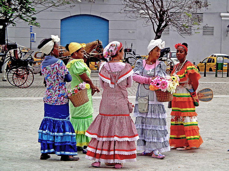 Flower sellers in Old Havana don traditional dress.