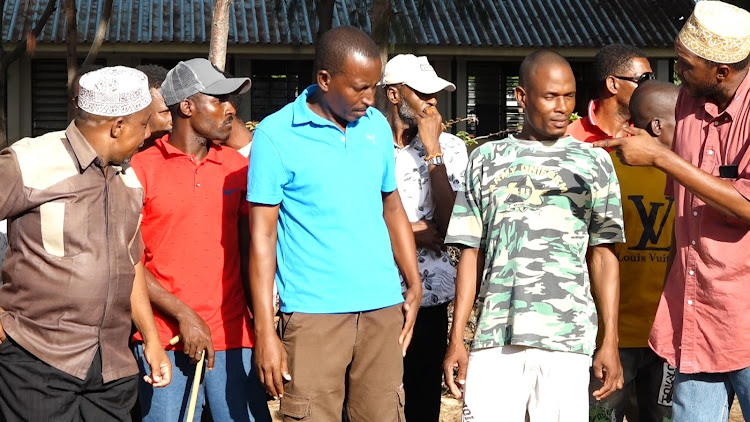 Some of the parents who were supporting the Principal of Ngomeni secondary school Twaha Mwatsahu addressing journalists at the school