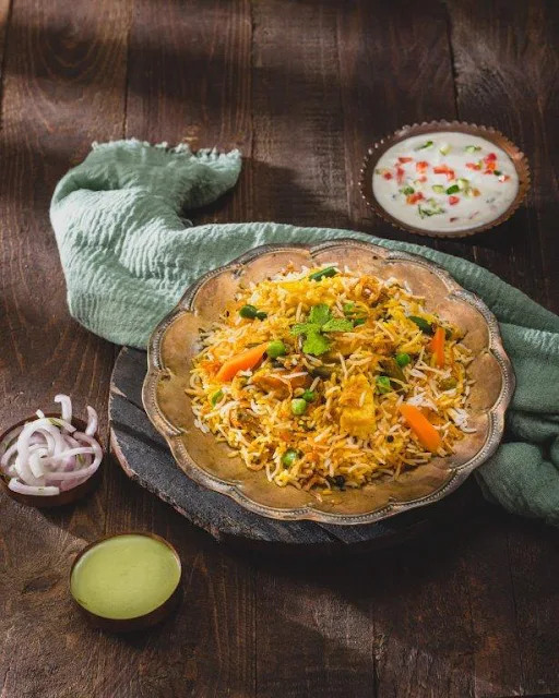 Dum Veg Biryani Served With Raita & Salad