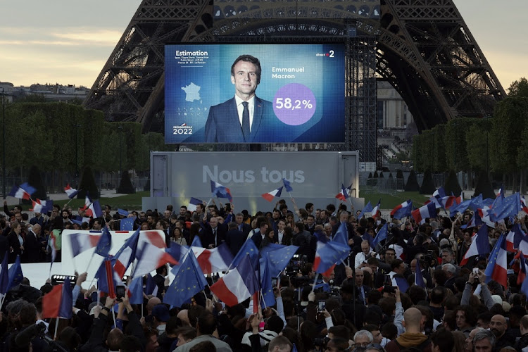 Supporters of French President Emmanuel Macron react after results were announced in the second round vote of the 2022 French presidential election, near Eiffel Tower, at the Champs de Mars in Paris, France, April 24 2022. Picture: BENOIT TESSIER/REUTERS