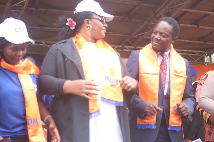 Nyamira ODM woman representative candidate Emily Matoke Nyagarama dances with governor candidate Timothy Bosire.