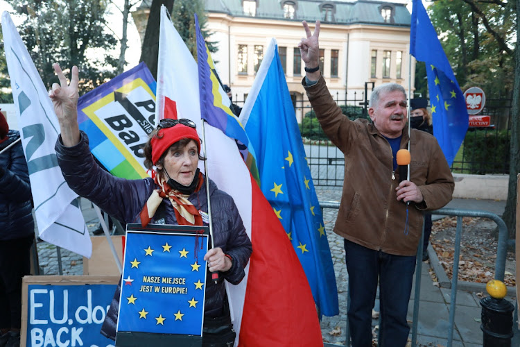 People demonstrate in front of the Constitutional Tribunal building, during a session ruling on whether several articles of EU Treaties comply with the Polish Constitution in Warsaw, Poland on October 7 2021. Picture: JACEK MARCZEWSKI/Agencja Gazeta via REUTERS