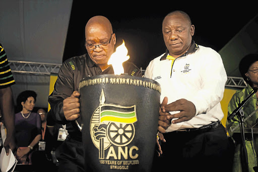 ANC president Jacob Zuma and his deputy, Cyril Ramaphosa, carry the ANC's centenary flame at the closing session of the party's national conference in Mangaung in December Picture: