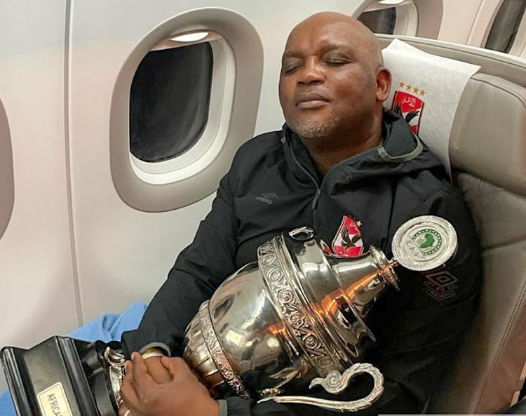 Pitso Mosimane flies home with the Caf Super Cup trophy he won with Al Ahly last week.