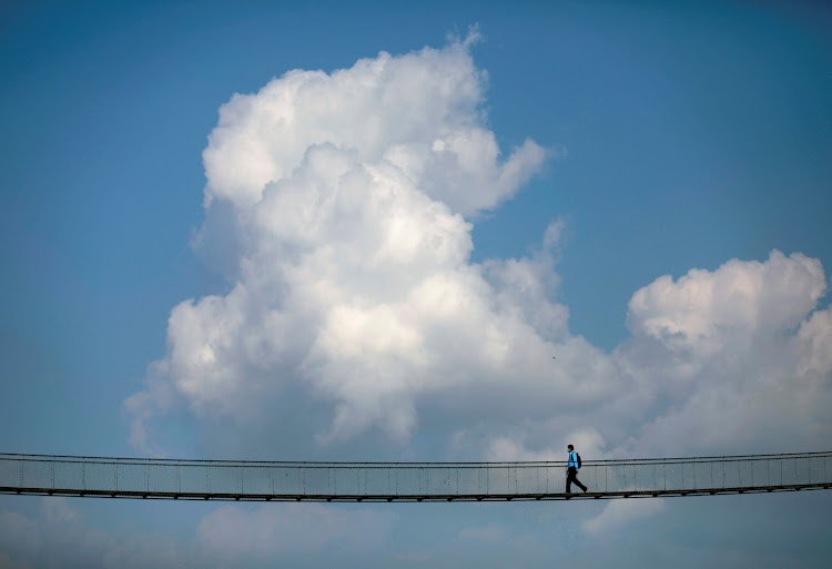A man walks on the suspension bridge in Kathmandu, Nepal.