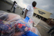 Businessman Phillip Sibia queues to return meat to the Enterprise Factory store in Germiston, east of Johannesburg on March 5 2018. File Photo.