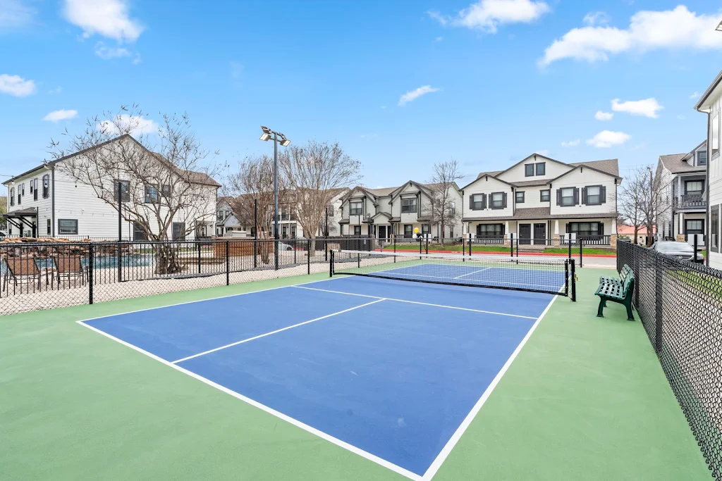 View of Pickleball court and community buildings on a nice day