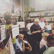 Protesters held up placards at the launch of investigative journalist Stephan Hofstatter’s book ‘Licence To Loot - How The Plunder Of Eskom And Other Parastatals Almost Sank South Africa’ at Love Books in Melville‚ Johannesburg on September 20 2018 