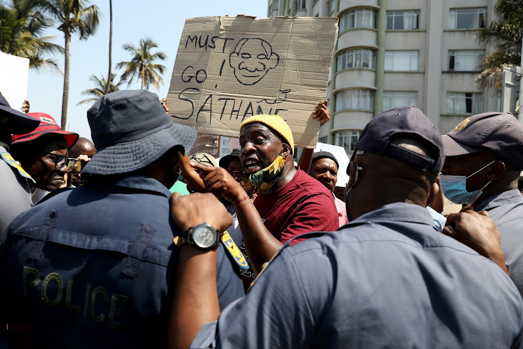 A protester clashes with a policeman at a march in Durban on Monday in opposition to government violation of people's freedom of choice